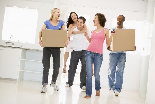 Professional movers carrying furniture from a Bedfordpark property with care