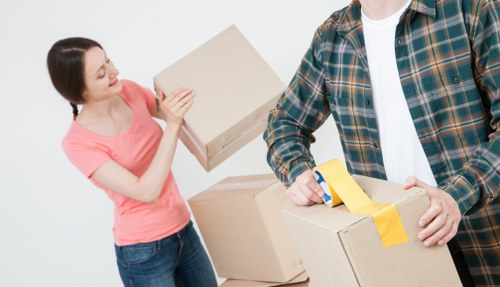 Packed moving boxes and protected furniture ready for transport