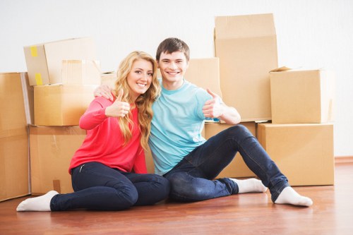 Local moving team carrying furniture on a Bedfordpark street