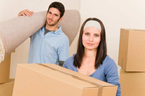 Movers carrying furniture through a residential property in Bedfordpark